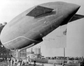 Ground crew working to berth air ship in the floating dirigible hangar - Pensacola, Florida.