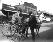 Men talking on Palafox Street while horse waits - Pensacola, Florida.