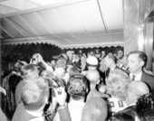 President Lyndon B. Johnson surrounded by crowd outside Fontainebleau hotel.