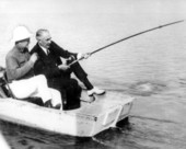 President Warren G. Harding reeling in a big one