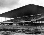 Spectator stand filled with crowd watching junk car races on Labor day - Pompano Beach, Florida.
