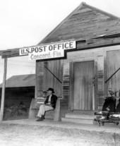 James Benjamin Walsh sitting on bench outside post office building - Concord, Florida