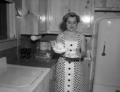 Unidentified woman pouring a cup of tea - Jacksonville, Florida.