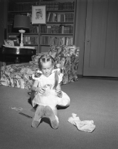 Darby Collins playing with a doll