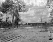 View of a street from an empty lot.