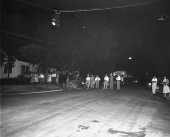People watching the Ku Klux Klan driving through town