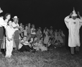 Crowd and Ku Klux Klan member at one of the Klan rallies