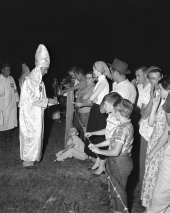 Crowd and Ku Klux Klan members at a Klan meeting