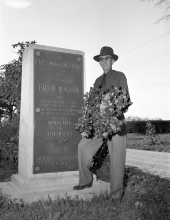 Fred Mahan standing beside the Fred Mahan Drive marker.