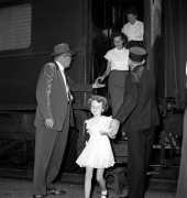 Conductor helping a girl off the train.