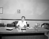 Woman working at the department of motor vehicles tag department.