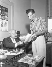 Men working at the department of motor vehicles tag department.
