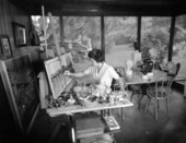 View showing artist Artemis Jegart at work painting - Tallahassee, Florida.