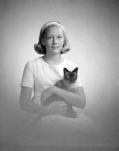 Portrait of Kim Mathews holding a Siamese cat - Tallahassee, Florida.