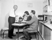 Lester Moon of Moon's Jewelers store assisting a couple with the selection of a gem - Tallahassee, Florida.