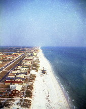 View showing a helicopter flying over Panama City Beach, Florida.
