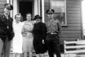 Midwife instructor Julia Graves, wearing black, standing with a group of people during World War Two.