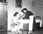 Patient having her blood pressure taken by a public health nurse.