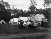 View showing people sitting together at a quarantined isolation camp.