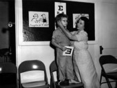 Child being fitting with eyeglasses during eyesight test at school.
