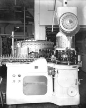 Machines filling and capping bottles at the Coca Cola Bottling plant.