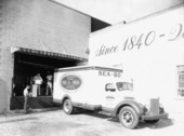 Workers loading beverages on to a truck.