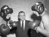Bill Moody giving instructions to young men preparing to box in Tallahassee, Florida.