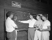 Leon High coaching staff holding a strategy session in Tallahassee, Florida.