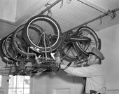 Officer Dick Granger of the Tallahassee Police Department hanging a bike for storage.