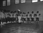 African American girl doing headstand exercise on the gymnasium floor at the new Dade Street Recreation Center in Tallahassee.