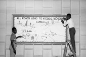 Students putting school lunch display on bulletin board in Tallahassee.