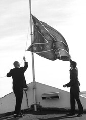 Kappa Alpha fraternity members hoisting the Confederate flag at the Capitol in Tallahassee to mark the anniversary of the Battle of Natural Bridge.