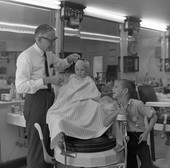Boy getting his first haircut from Tom Fair in Tallahassee.
