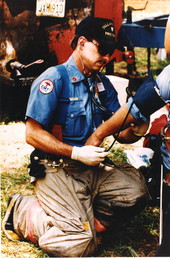 Tallahassee Fire Department EMT Lt. Stanley "Stan" E. Burcham administering aid.