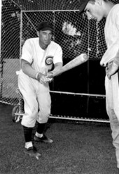 Coach Jim Oglesby shows rookie Joe Barracato how to hit - Miami, Florida