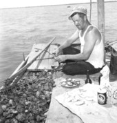 Captain White eating oysters - Apalachicola, Florida