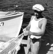 Commercial fisherman mending nets.