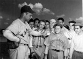 Cincinnati Reds pitcher Johnny Vander Meer showing Murray Newman and other students a straight ball grasp - Tampa, Florida.