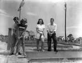 Four people play miniature golf - Saint Augustine, Florida.
