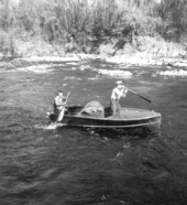 Men running the rapids in the Suwannee River.