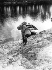 Von Walker carries supplies to the shore of the Suwannee River .