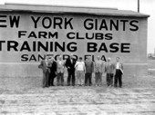 Legislators in front of a sign at the Giant's farm club camp - Sanford, Florida