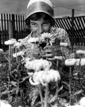 Woman smelling the flowers at Pineland Farms in Delray Beach, Florida.