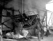 View of Florida Steel Corporation employees working with furnace machinery at foundry - Tampa, Florida.