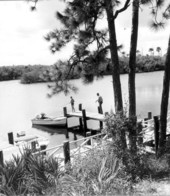 Jonathan Dickinson State Park visitors fishing from dock at Hobe Sound - Martin County, Florida.
