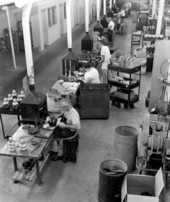 Interior view showing employees working at the Perkins Marine Lamp and Hardware Corporation in the Sunshine State Industrial Park - North Miami, Florida.