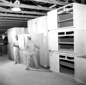 Workman storing completed cabinets - Panama City, Florida