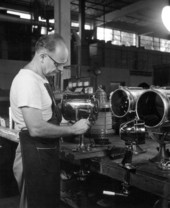 Unidentified employee during final assembly of a searchlight - Miami, Florida