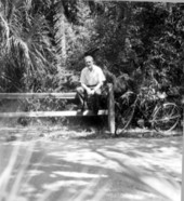 Cyclists takes a break on a fence - Cocoa Beach, Florida