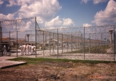 Close-up view showing barbed wire fence at the Central Florida Reception Center.